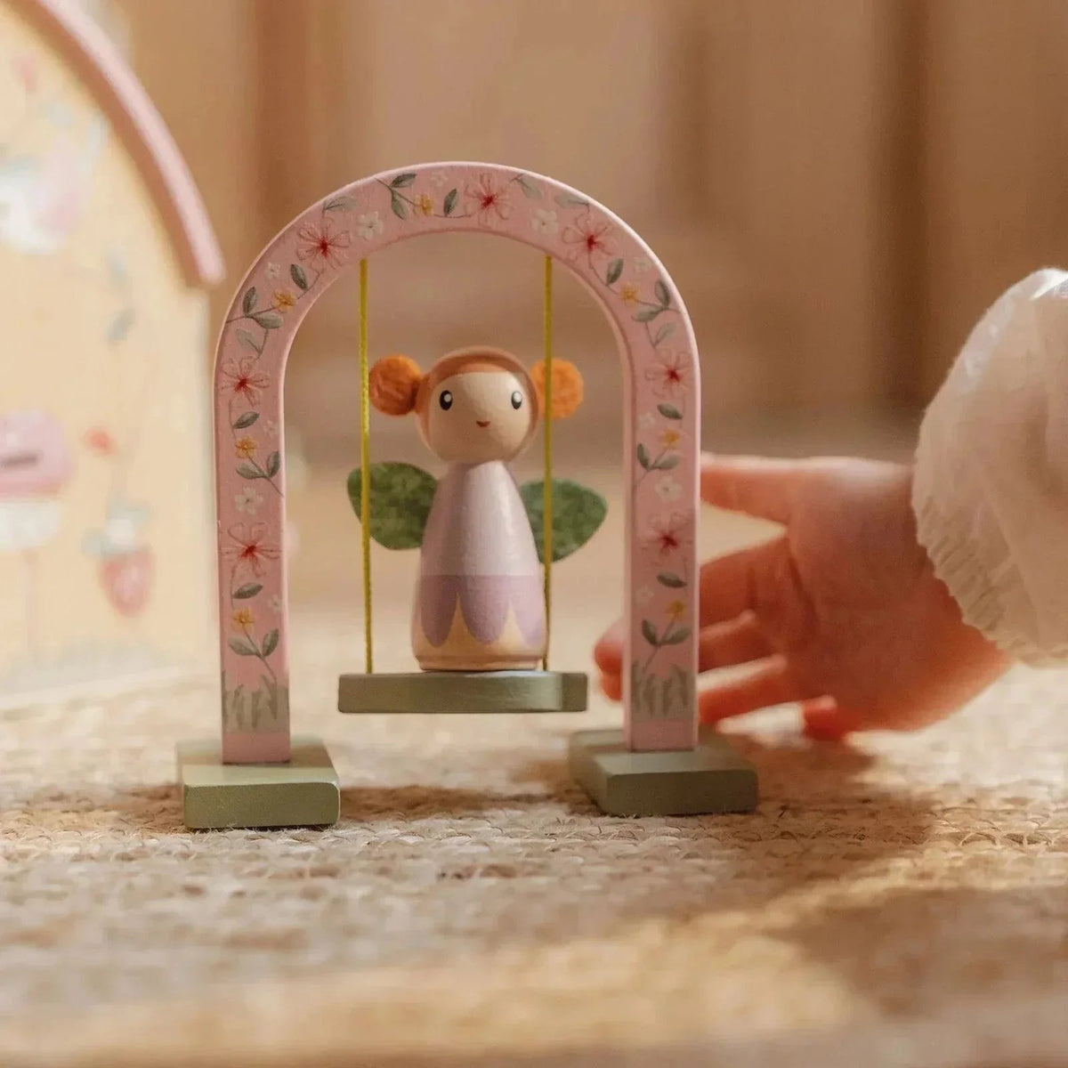 Little Dutch Fairy House & Garden wooden fairy swing toy with pink floral arch.